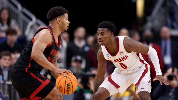 San Diego State Aztecs guard Matt Bradley (20) dribbles against Alabama Crimson Tide guard Jaden Bradley (0) during the first half of the NCAA tournament round of sixteen at KFC YUM! Center.